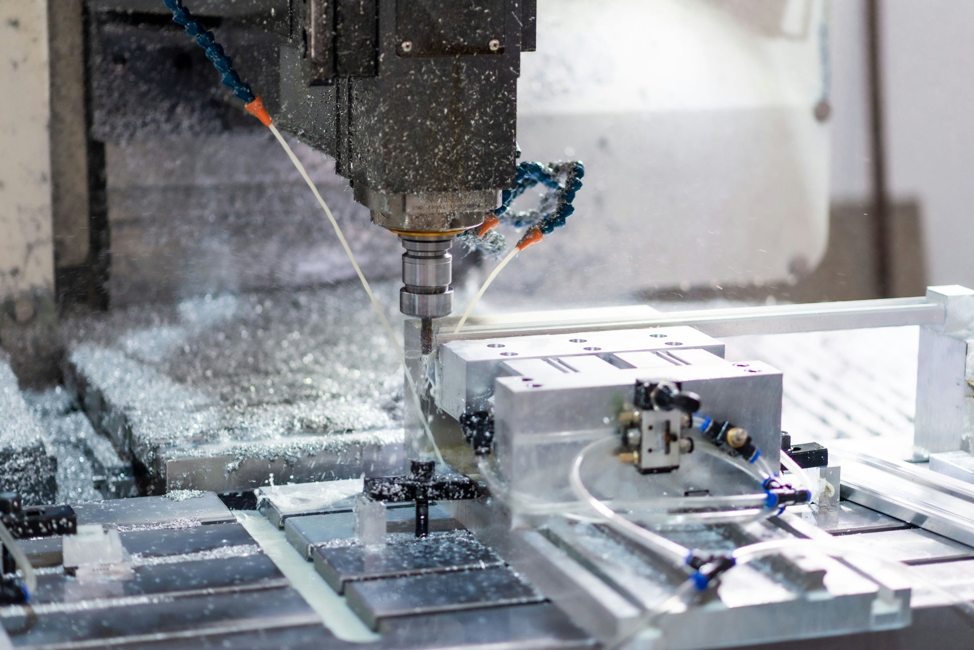 Close-up of a CNC machine cutting aluminum parts with high precision.