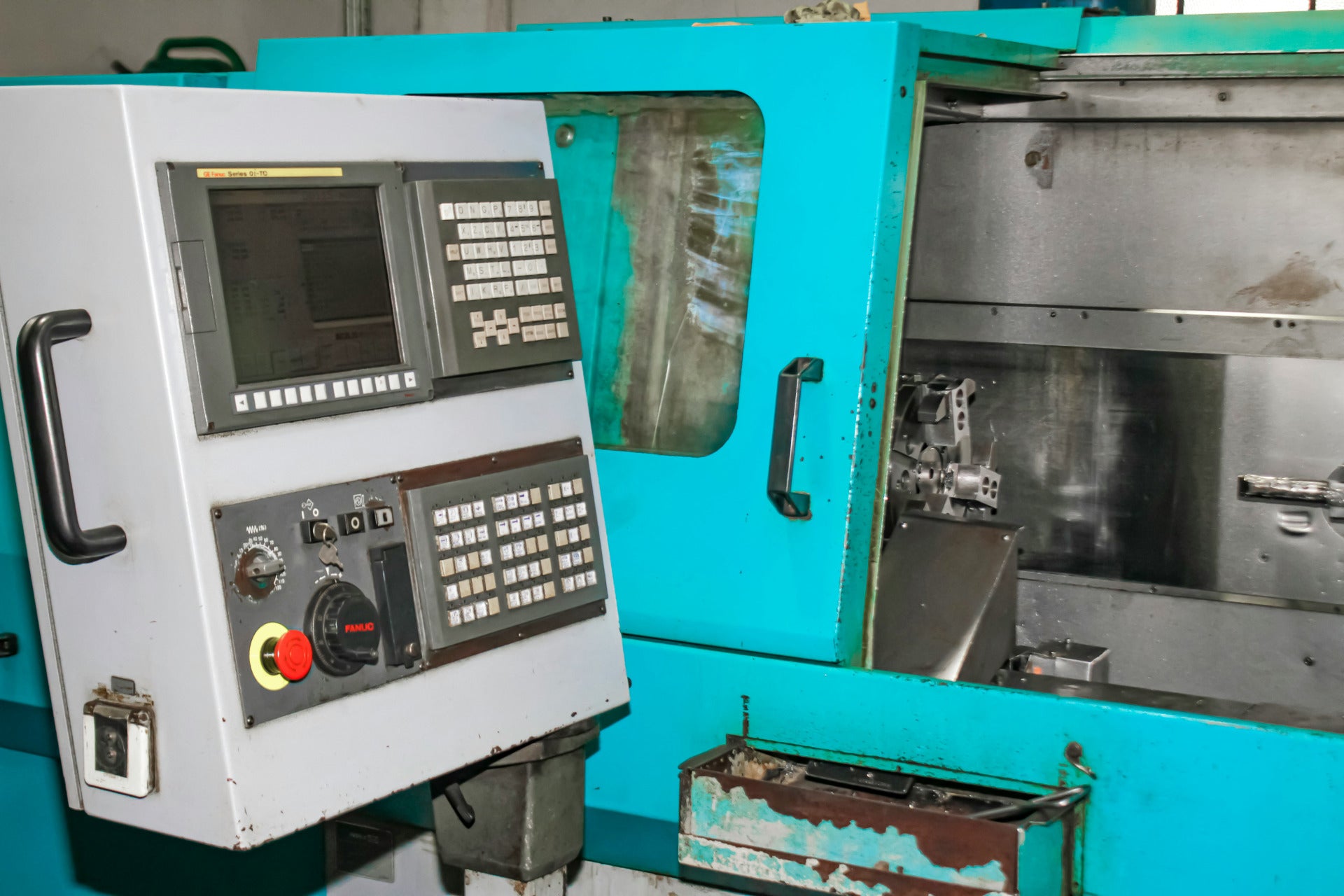 Industrial CNC control panel and machining center used for automated metalworking.